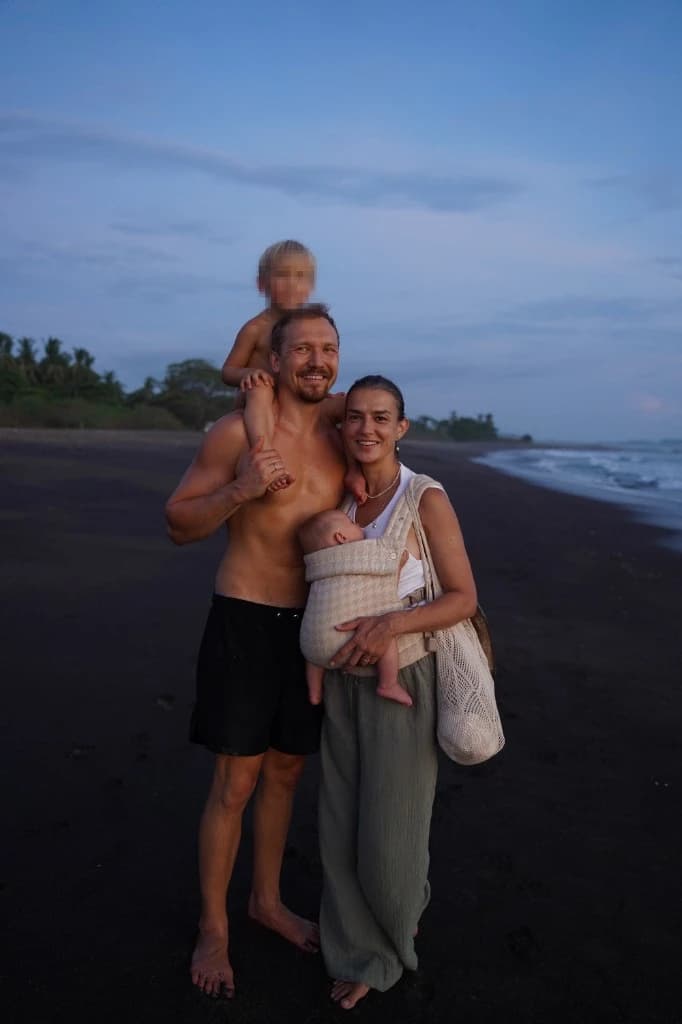 Andri Peetso with his wife and their two kids on the beach
