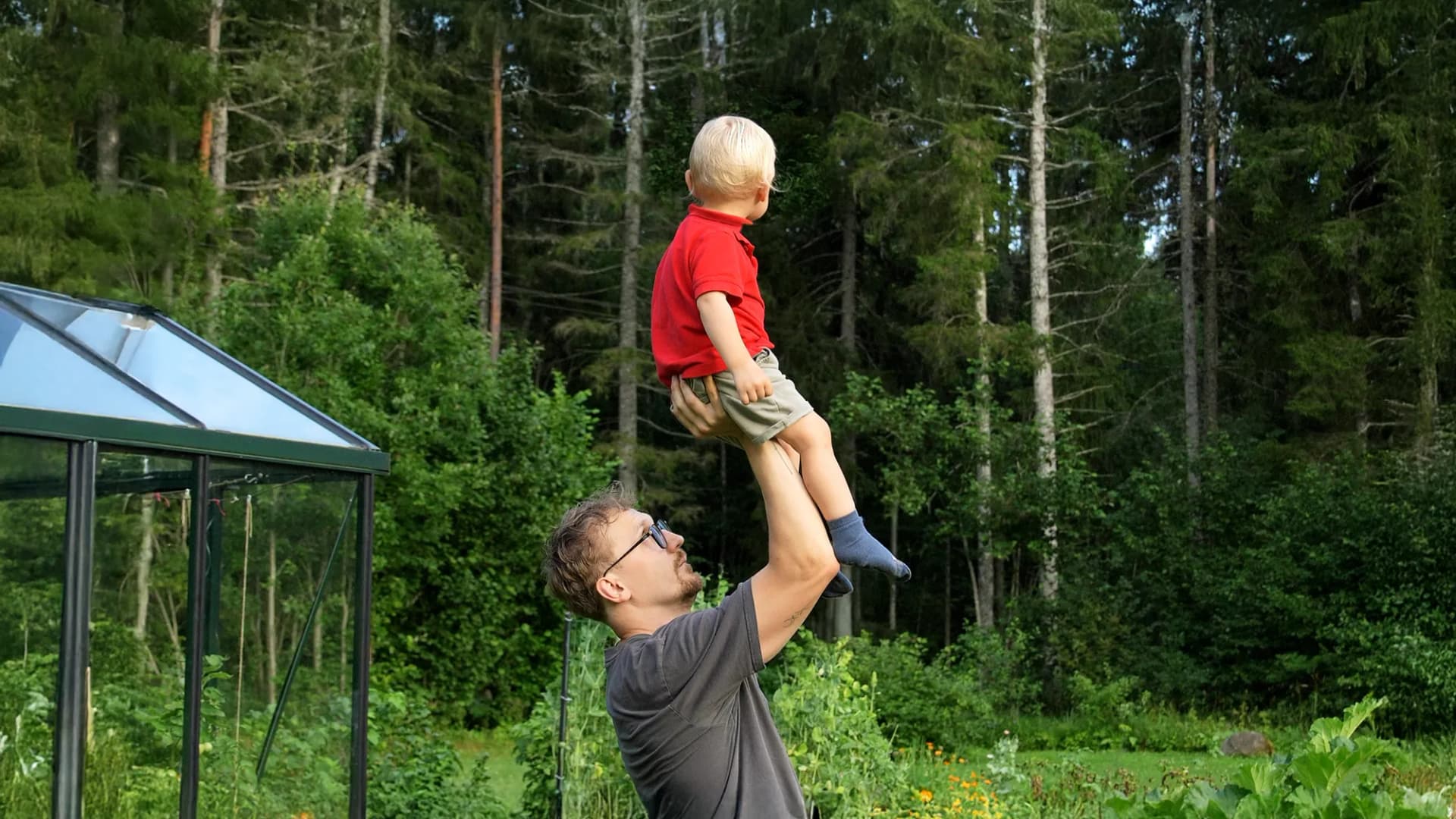 Parent supporting baby in movement session