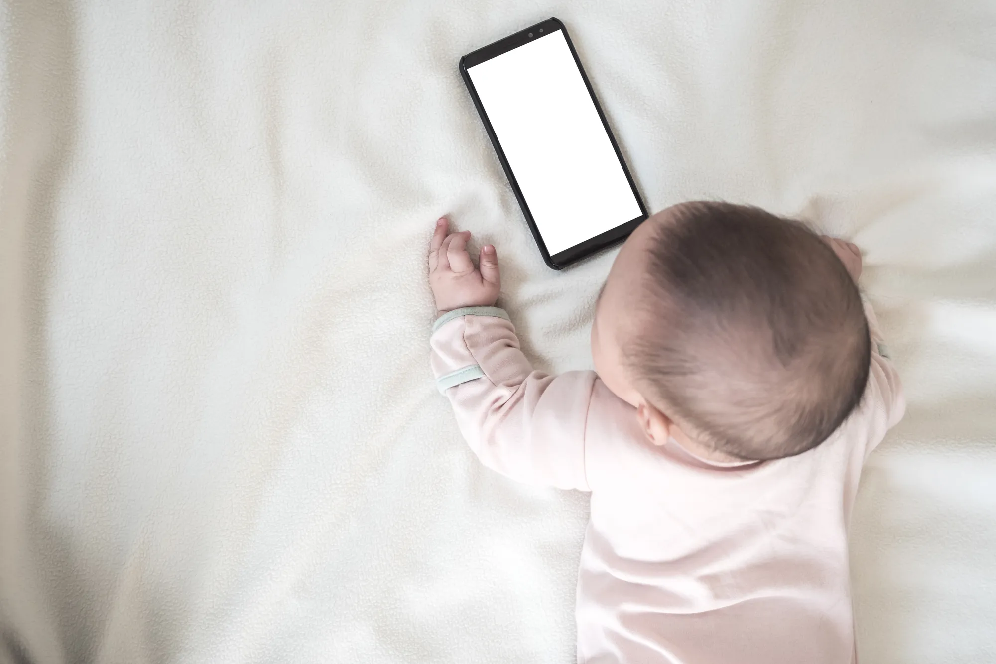Baby looking at mobile phone screen