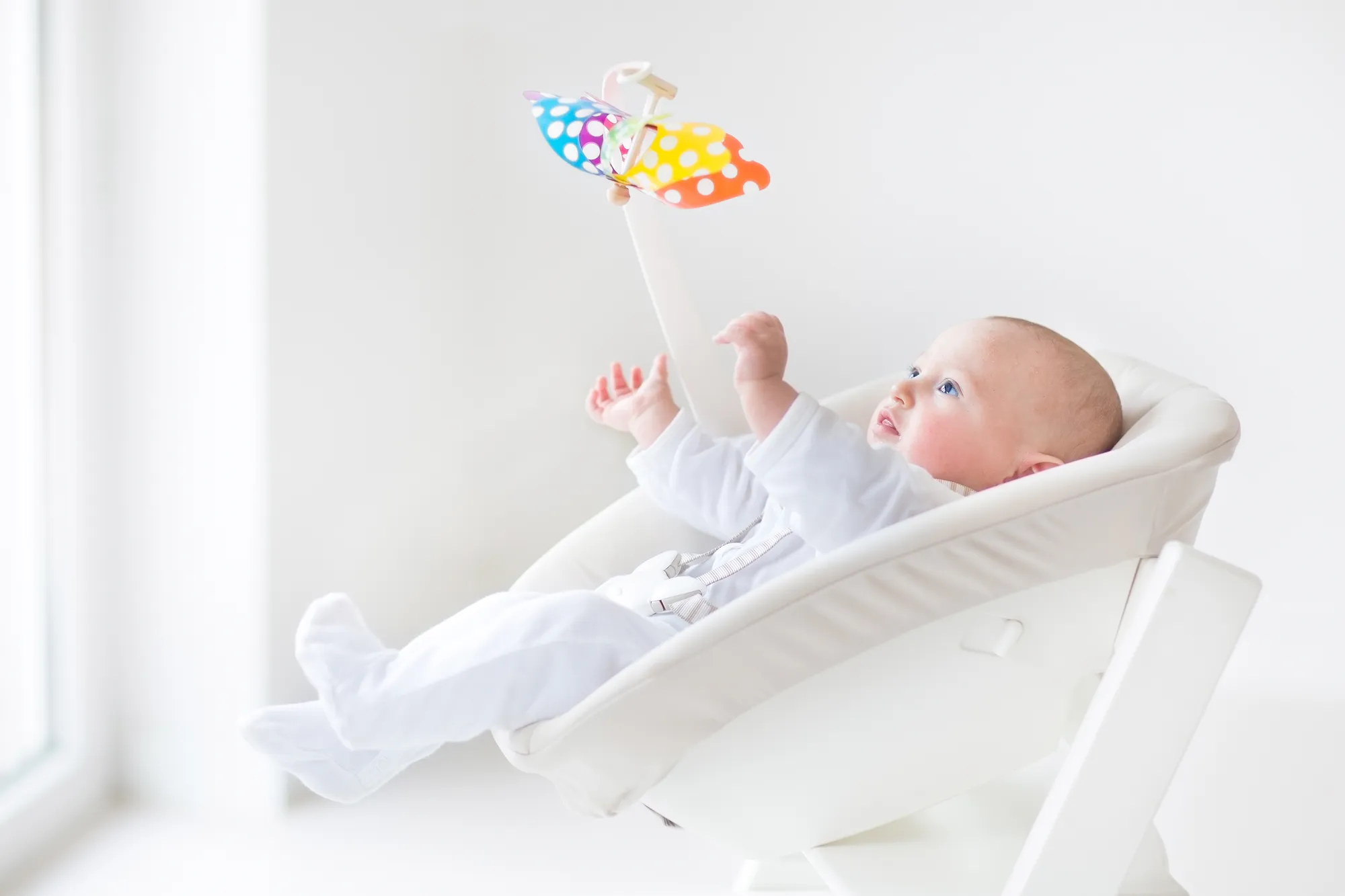 Baby watching colorful mobile toy