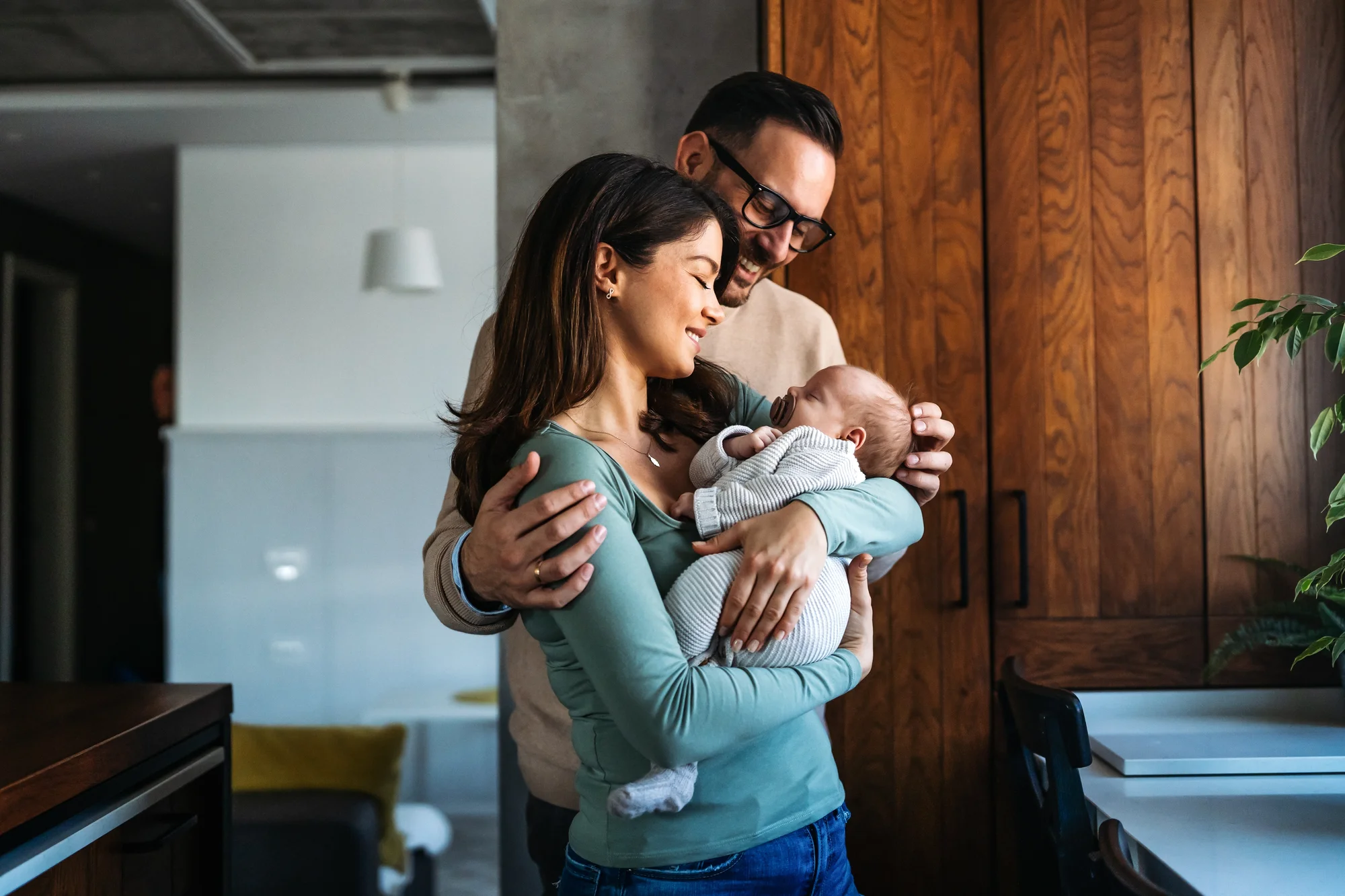 Mother and father lovingly looking at baby