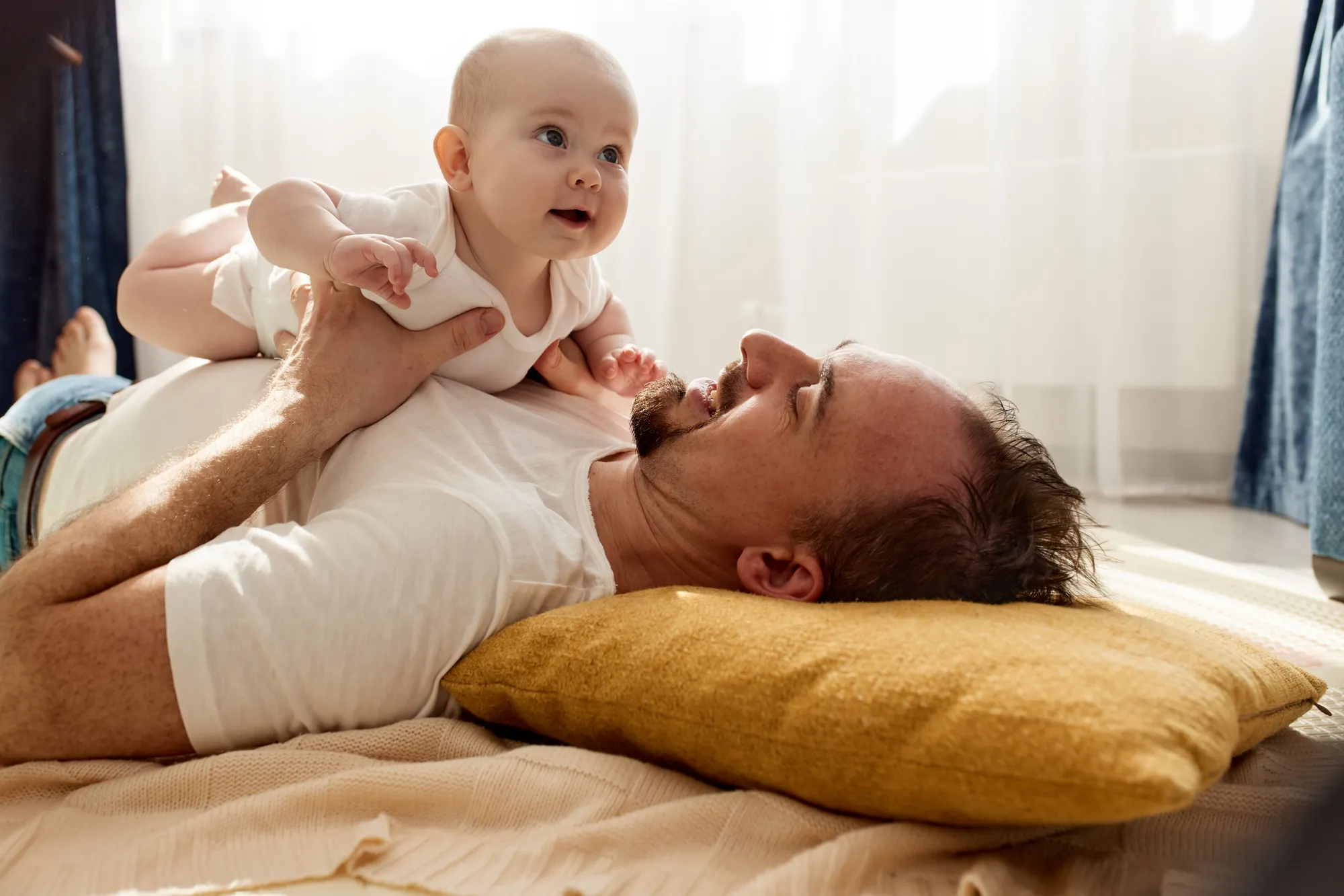 Happy dad holding his newborn baby