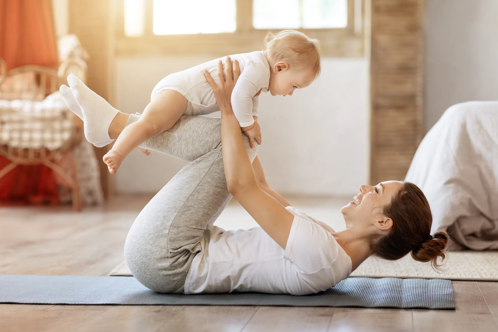 Parents sharing evening routine with baby on the living room floor